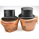 Two top hats in leather cases, one Army & Navy, aperture 20.5 x 16.5cm, the other McLaren & Son,