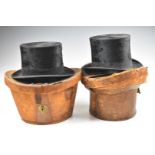Two vintage top hats in leather cases, one Dunn & Co., London the other 'W' make Stockport, both