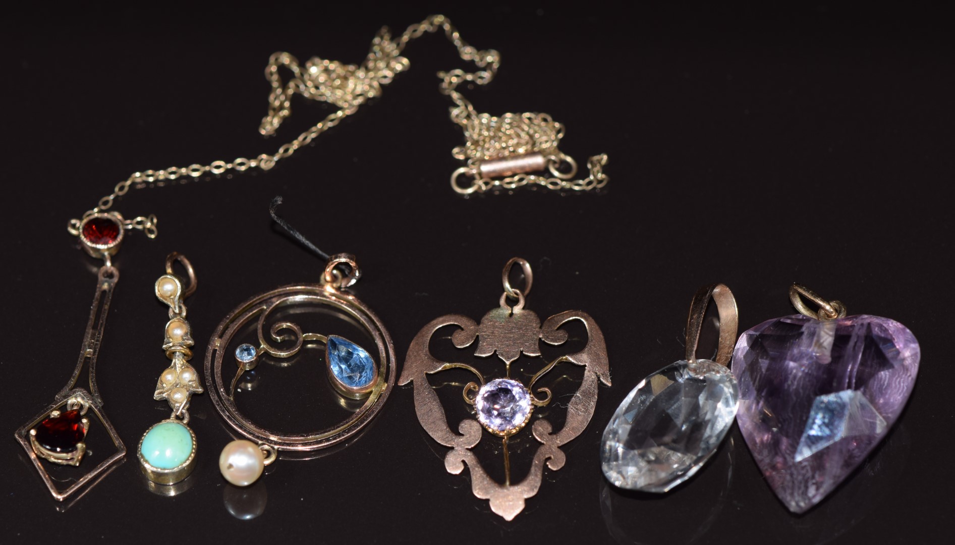 Four 9ct gold c1900 pendants set with turquoise, amethyst, garnets and paste (5g) together with an