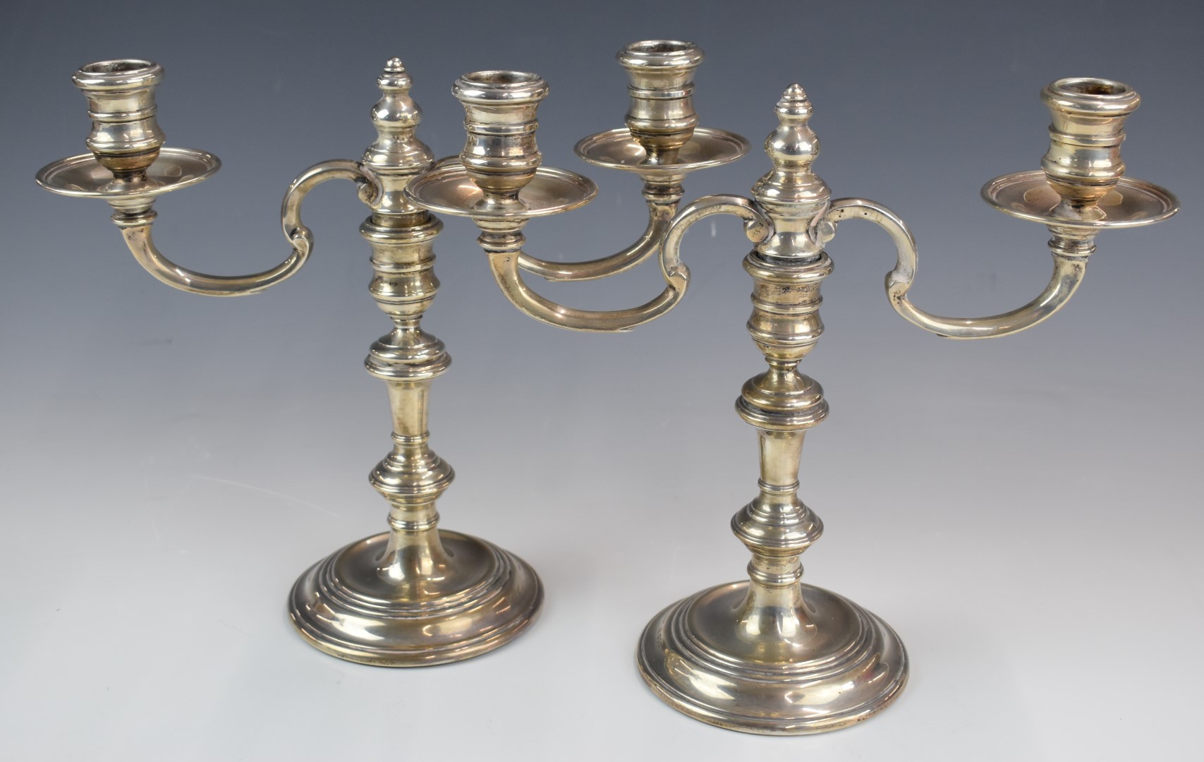 Pair of Elizabeth II hallmarked silver two branch candelabra, the tops being removable to form