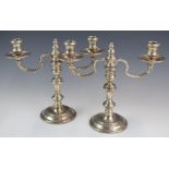 Pair of Elizabeth II hallmarked silver two branch candelabra, the tops being removable to form
