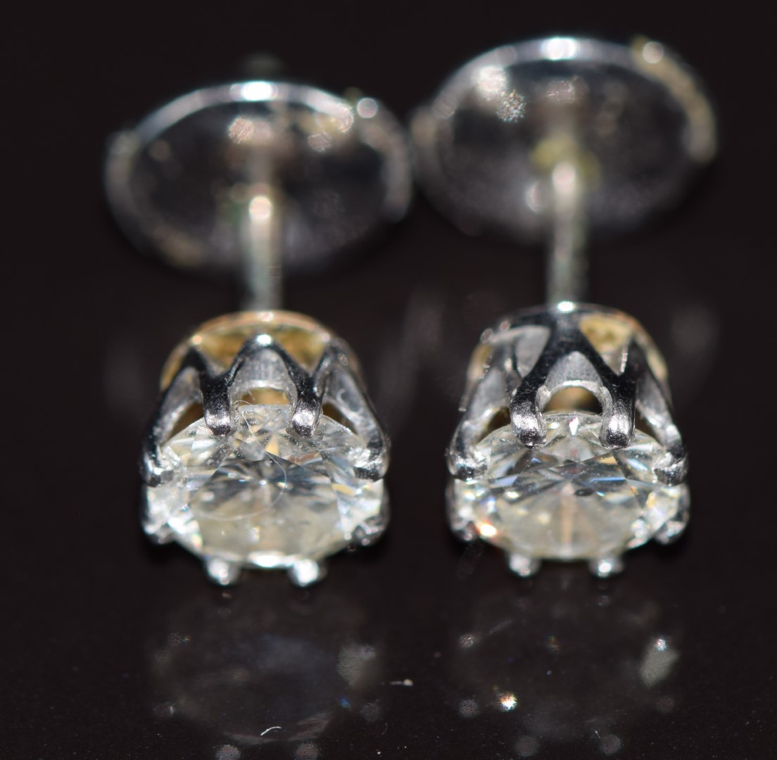A pair of 18ct white gold earrings set with round cut diamonds of approximately 0.6 and 0.7ct, 2. - Image 3 of 3