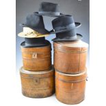 Four tin hat boxes containing bowler hats and a straw boater