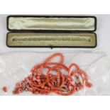 A beaded single strand coral necklace with 9ct gold clasp, a double stranded coral necklace with