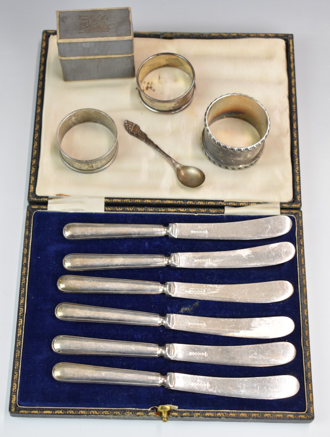 Hallmarked silver items comprising three various napkin rings, salt or mustard spoon and a cased set