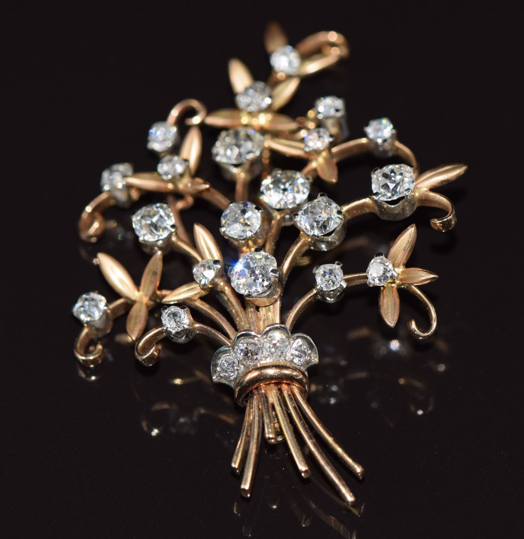 An 18ct gold brooch, c1910, in the form of a bouquet of flowers set with old cut diamonds, the