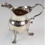 Georgian hallmarked silver milk jug raised on three feet, London 1757, maker's mark rubbed but
