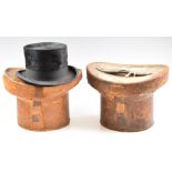 Two vintage top hats, in leather cases, one tapering example by Hanbidge, Sheffield 19 x 15cm, the