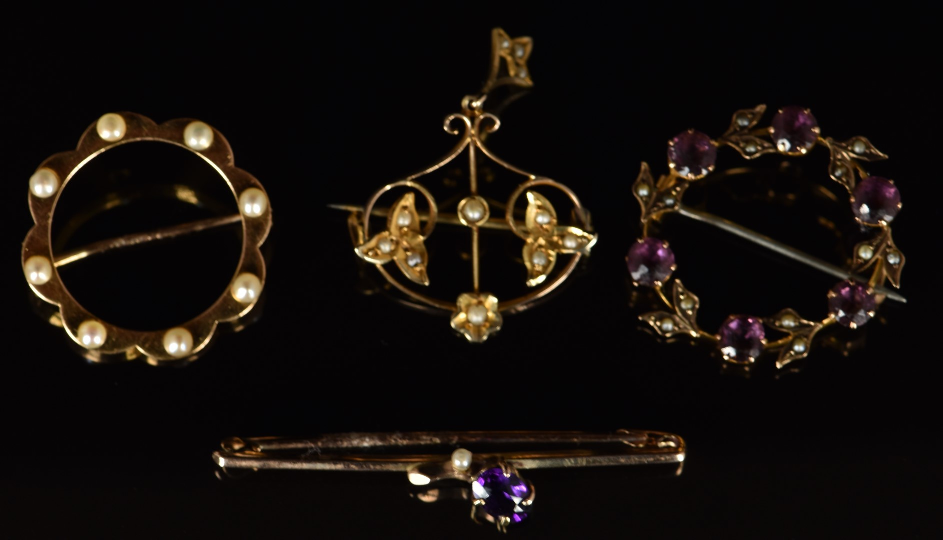 Four Edwardian 9ct gold brooches set with amethysts and seed pearls, 9.4g