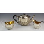 Edward VII or George V hallmarked silver three piece tea set with reeded lower body, the milk jug