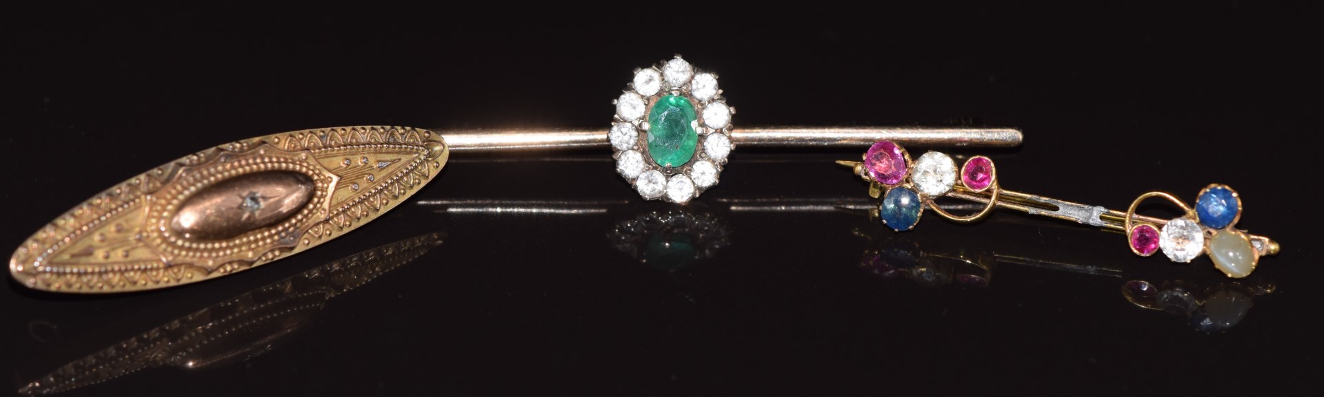 A 9ct gold brooch set with an oval cut emerald surrounded by white sapphires, a Victorian 9ct gold