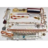 A collection of costume jewellery including amber necklace, filigree bracelets, silver ring,