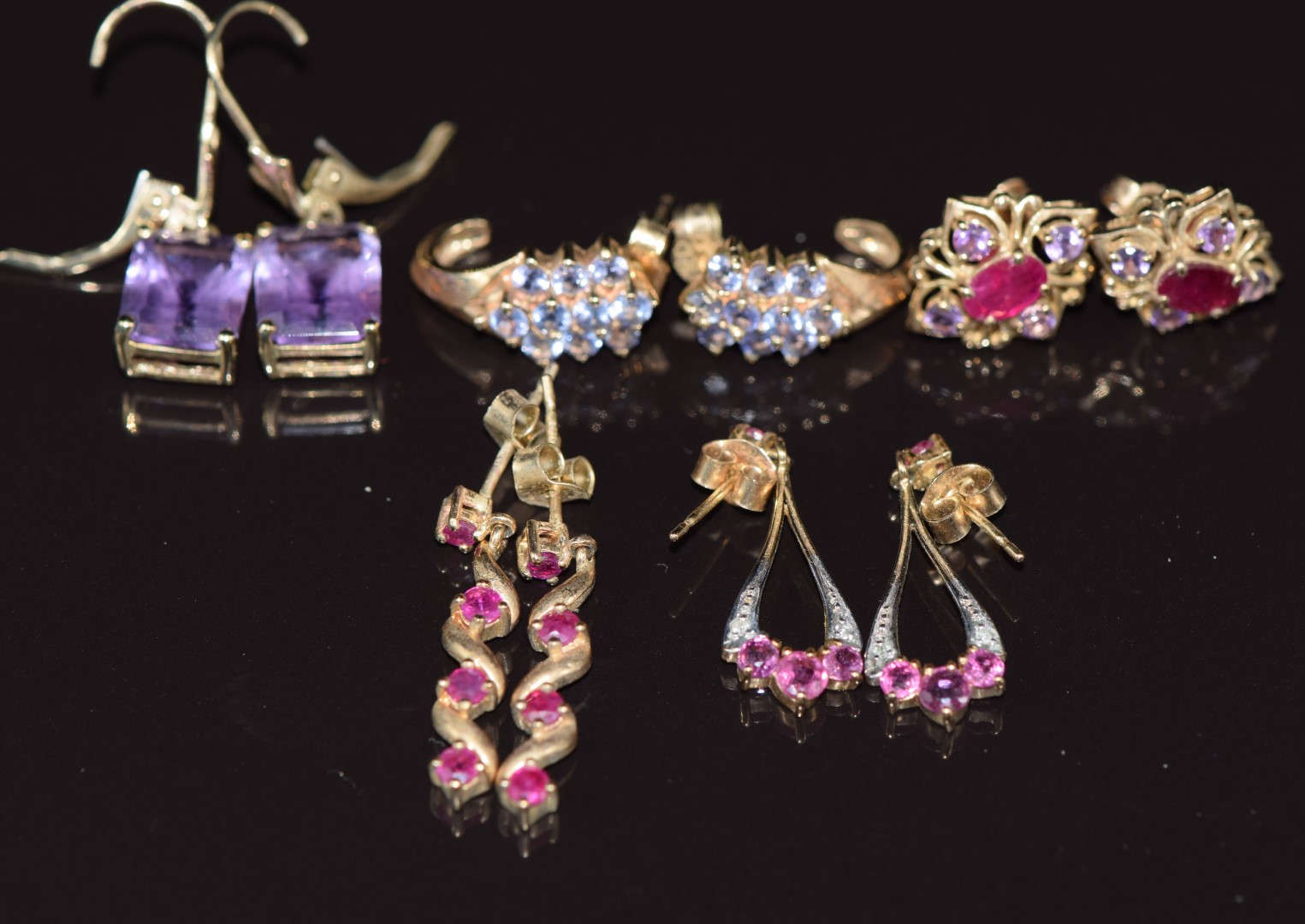 Five pairs of 9ct gold earrings set with amethysts, rubies, and tanzanites, 12.3g