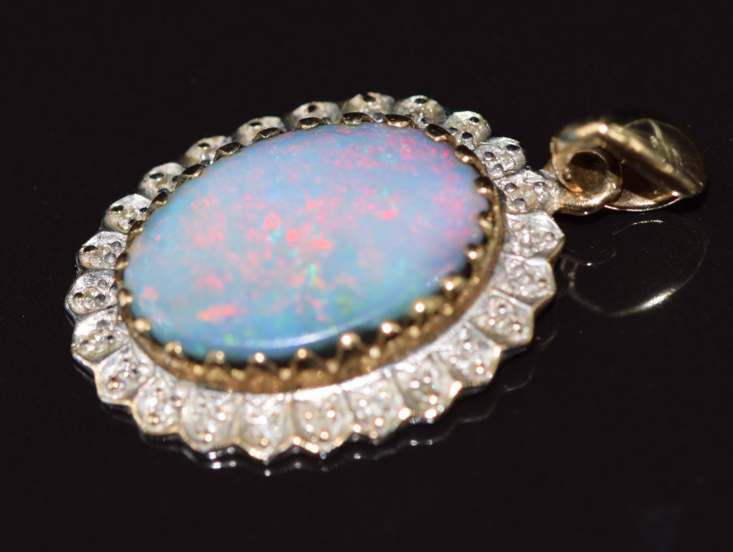 A 9ct gold pendant set with an opal surrounded by diamonds, 2.4g - Image 2 of 3