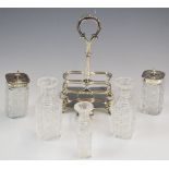 Victorian hallmarked silver cruet set on stand, with five cut glass bottles, raised on hoof feet