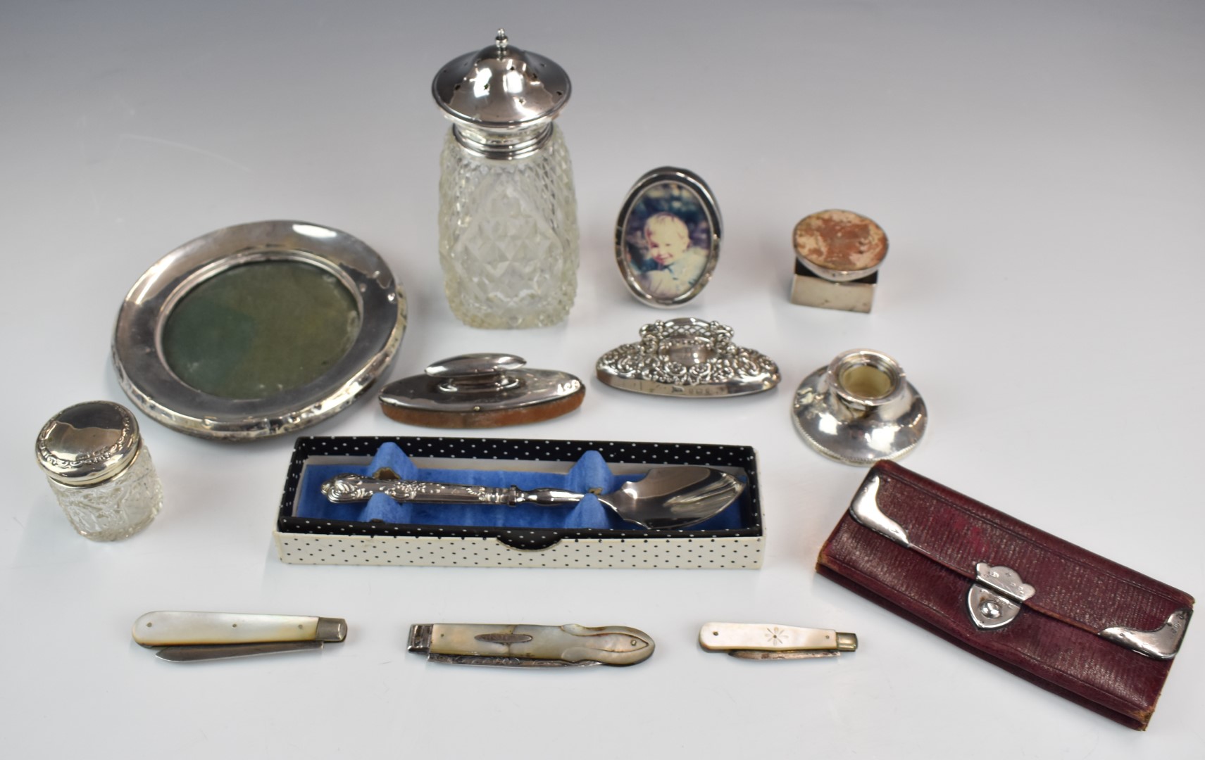 Hallmarked silver mounted items to include sugar sifter, photograph frames, matchbox holder, nail