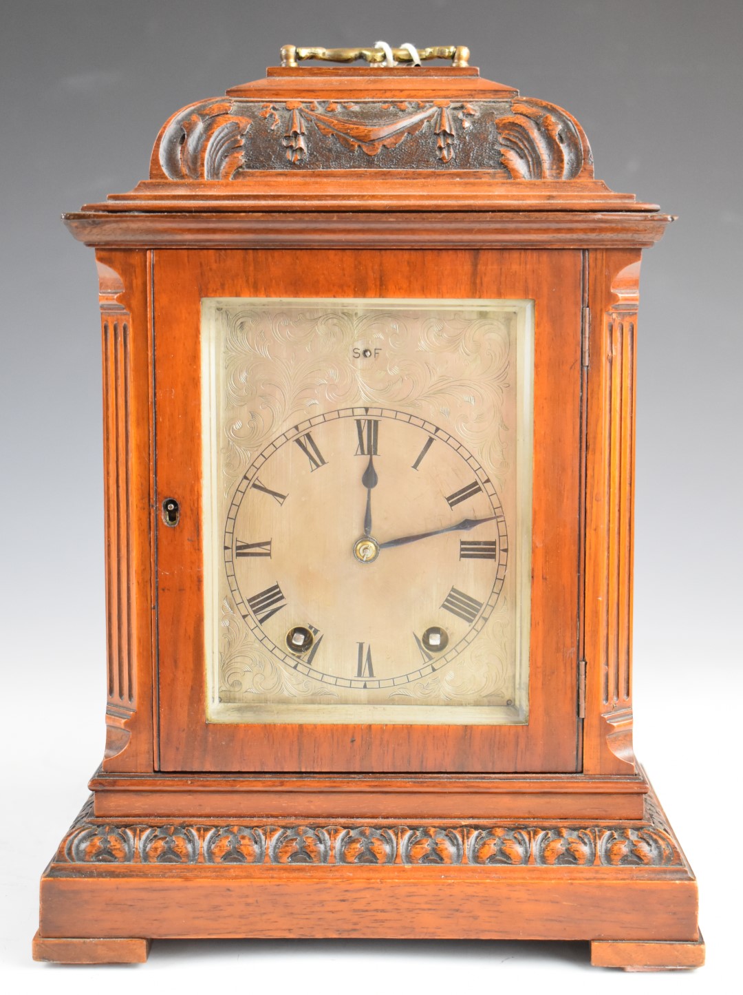 19th or early 20thC mahogany bracket clock with carved decoration, the silvered dial having slow and