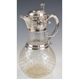 Victorian hallmarked silver and cut glass claret jug with embossed decoration and hinged lid, the