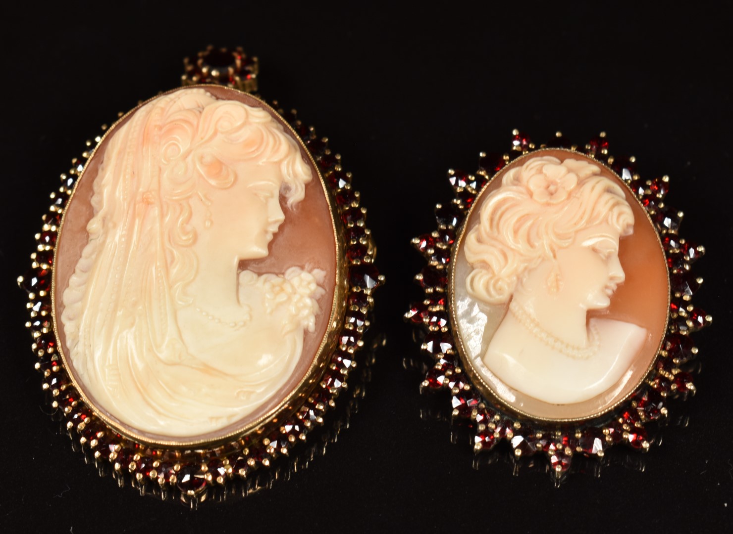 Two silver brooches each set with a cameo surrounded by Bohemiam cut garnets, a silver brooch set - Image 2 of 2