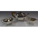George VI Art Deco hallmarked silver three piece tea set of octagonal form, raised on four feet,