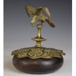 Brass or similar model of a bird with outswept wings, currently mounted on a brass and wooden base