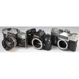 Three 35mm SLR cameras comprising Nikon FM2, Moscow Olympics Zenit-E and Petri Flex with 1:2 f=