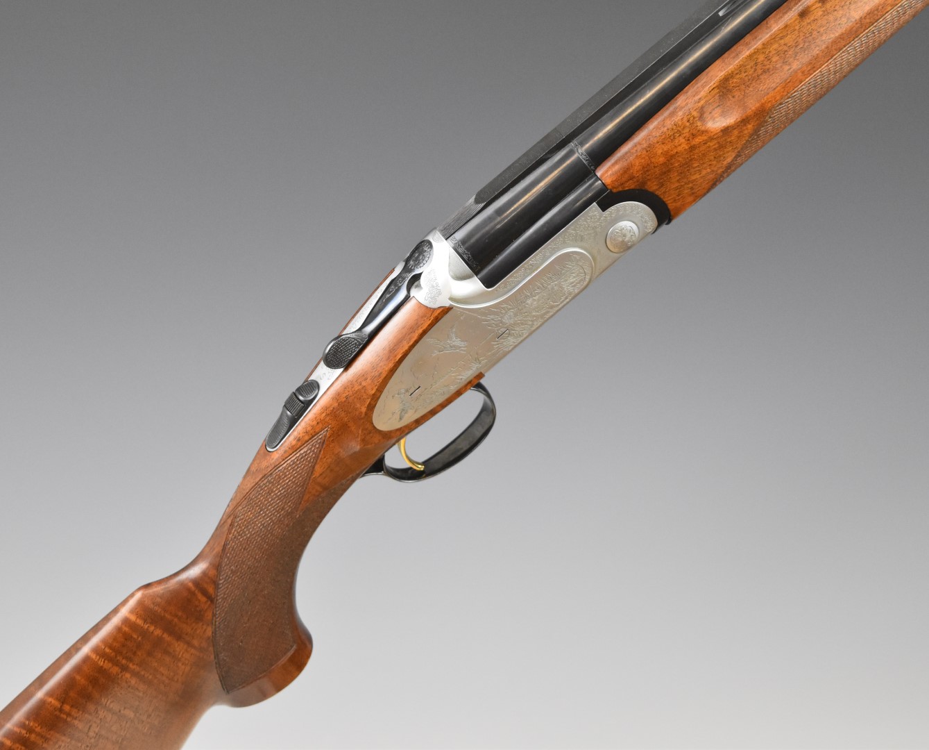 Sabatti 12 bore over under ejector shotgun with engraved scenes of birds to the sidelock plates