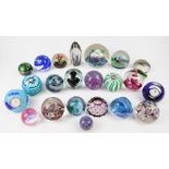 Twenty-two glass paperweights including Murano, Caithness, Strathearn and Selkirk magnum, one with