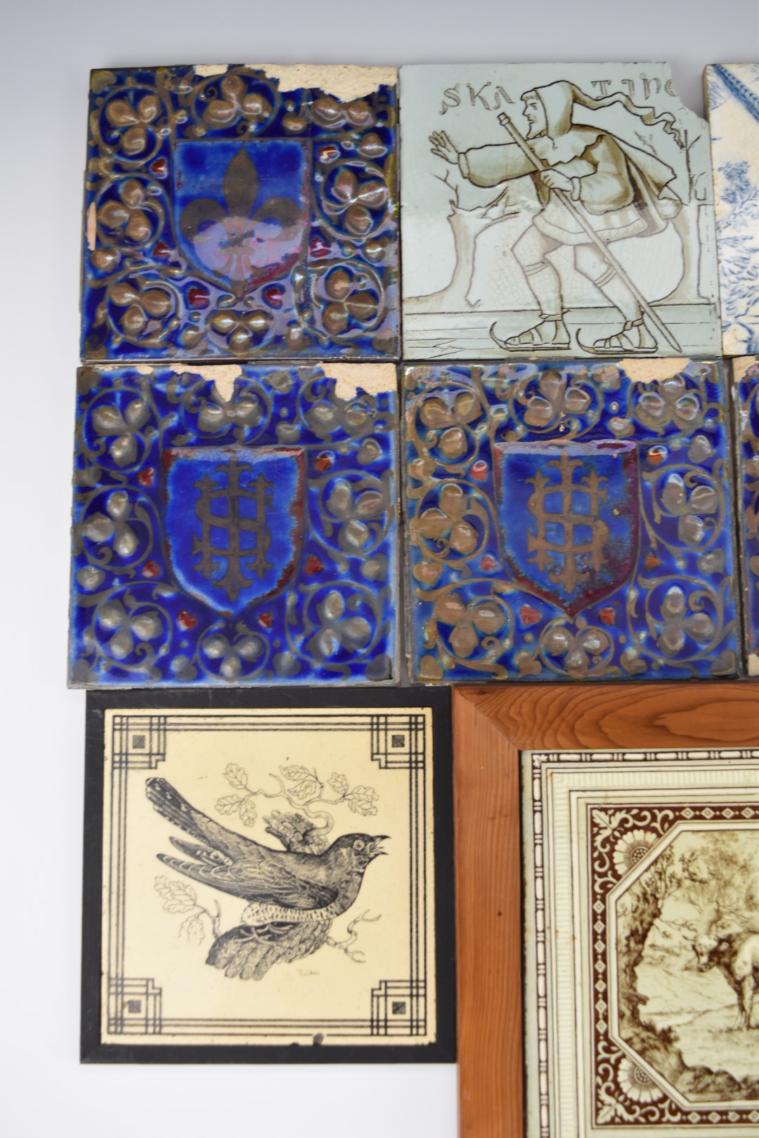 Eleven various ceramic tiles including Wedgwood, Minton, Maw & Co. and