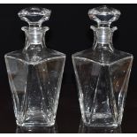 A pair of Baccarat clear faceted glass decanters and stoppers, 23cm tall.