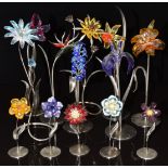 Thirteen Swarovski Crystal glass flowers, all on metal stands, largest 24.5cm tall.