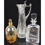 Three glass jugs and decanters comprising an Orrefors clear faceted decanter, an amber glass