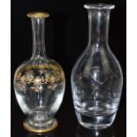 Two glass decanters, one Baccarat with gilt decoration the other Villeroy and Boch, both with etched