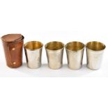A set of four silver plated drinking cups in leather case.