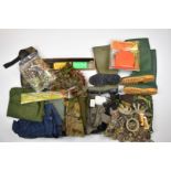 A collection of gun and shooting accessories including cleaning kits, shotgun cartridge and