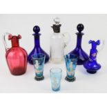 Eight pieces of clear and coloured glassware including a pair of Bristol Blue ship's decanters and
