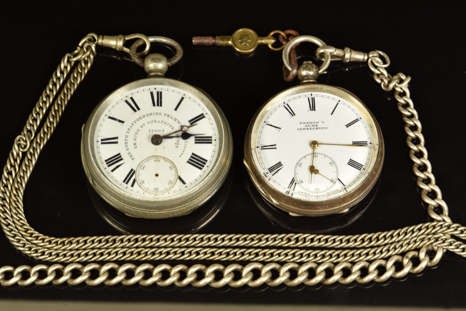 Two open faced pocket watches Paxman's Acme of Tewksbury silver example on silver chain with fob and