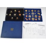 A collection of reproduction hammered coins in a Westminster case, with some decimals etc