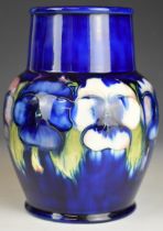 William Moorcroft pottery pedestal vase decorated in the Pansy pattern, signed to base, circa 1930s,