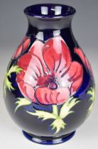 Moorcroft pottery pedestal vase decorated in the Anemone pattern, height 20cm