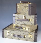 Four Maionchi leather and canvas bound cases comprising a briefcase, 100 and 50 cartridge carrying