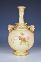 Royal Worcester twin handled blush ivory pedestal vase with mask handles, height 26.5cm