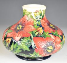 Moorcroft pottery pedestal squat vase decorated with red exotic flowers on a pink ground, height