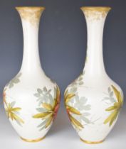 Pair of signed Doulton Lambeth Carrara pedestal vases with K R monogram, height 35cm