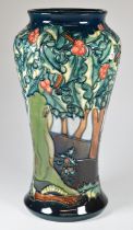 Moorcroft pottery pedestal baluster vase decorated in the Holly Watch pattern, height 27cm