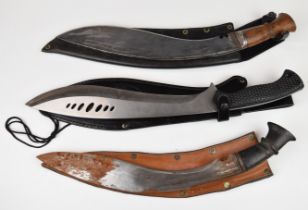 Two Kukri knives and a modern Kukri type knife, largest blade 33cm, all with sheaths. PLEASE NOTE