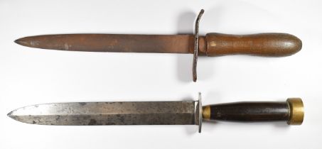 Two trench / fighting knives, both with wood grips and double edged blades, longest blade 21cm.