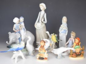 Lladro, Karl Ens and Goebel figures including children riding on an elephant, girl brushing her dog,