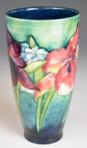 William Moorcroft pottery tapering vase decorated in the Iris / Spring Flowers pattern, circa 1930s,