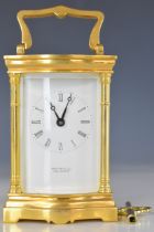 Martin & Co, Cheltenham brass cased bevelled glass serpentine fronted carriage clock, height 16cm